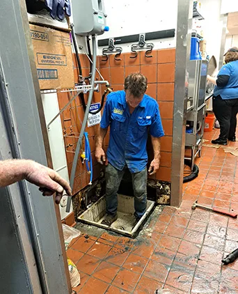 Plumber standing in grease trap